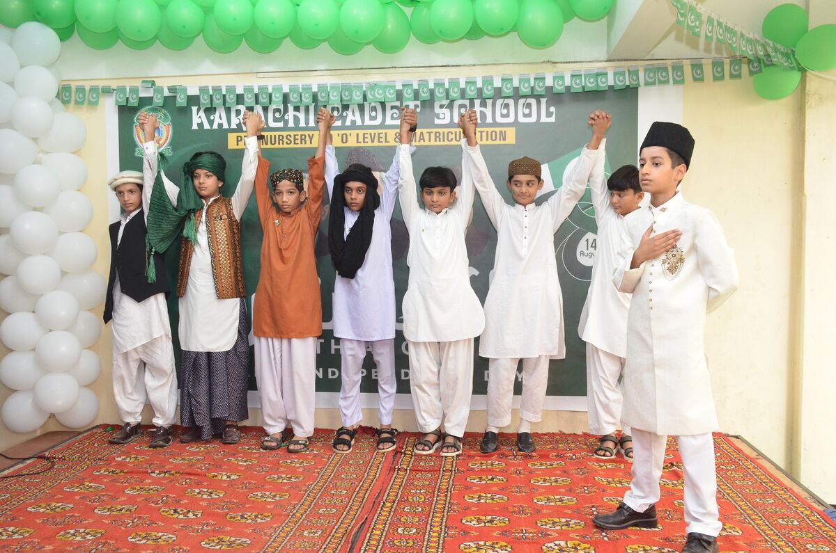 Students in traditional dress performing an Independence Day skit