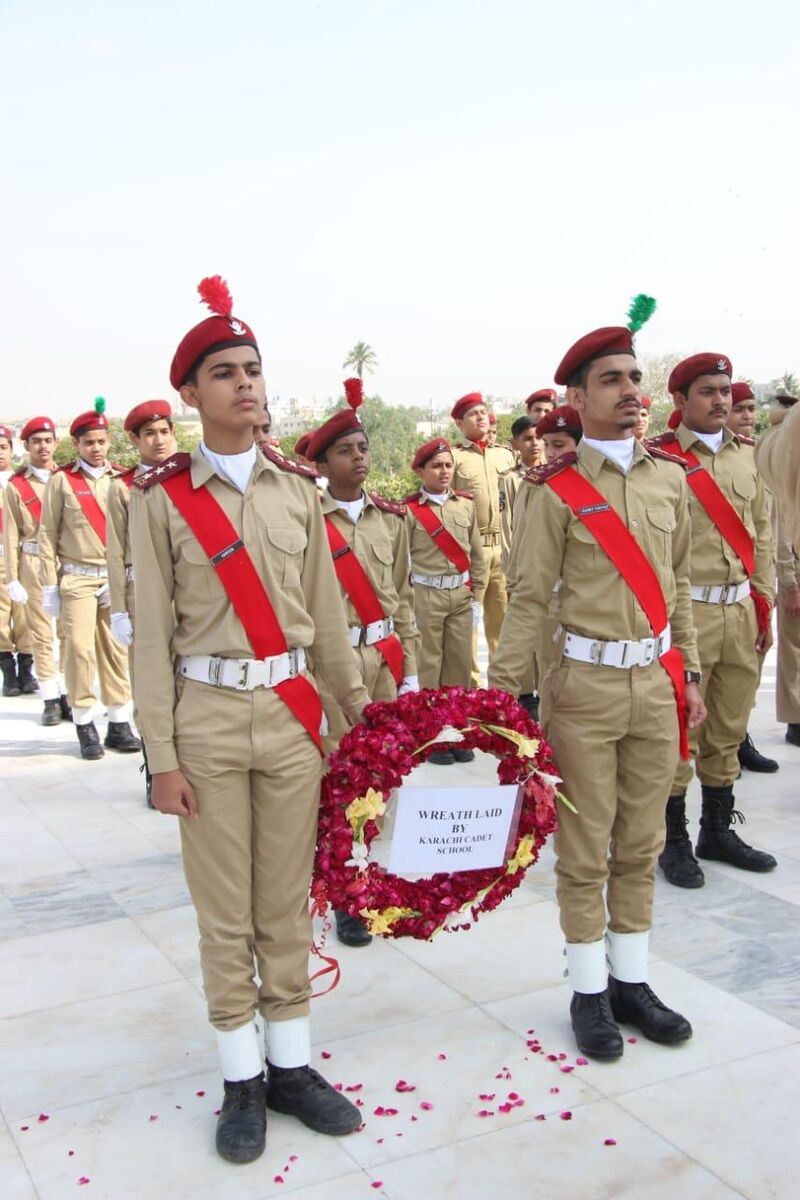 KCS cadets saluting beside the school's wreath at Mazar-e-Quaid